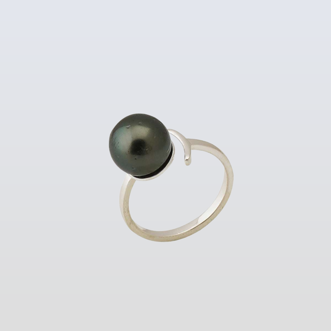 Silver ring with a black pearl on a light gray background