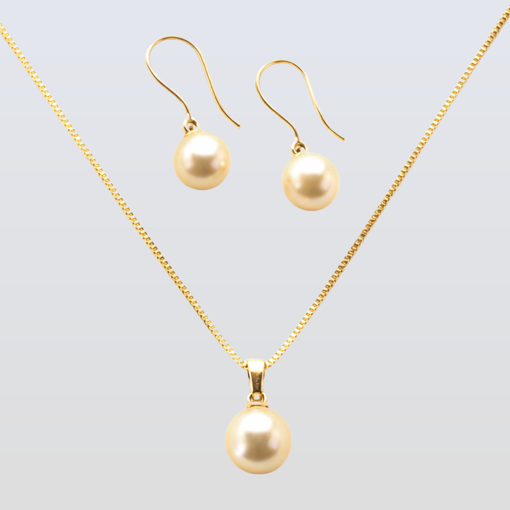 Gold necklace and earrings set on a light gray background