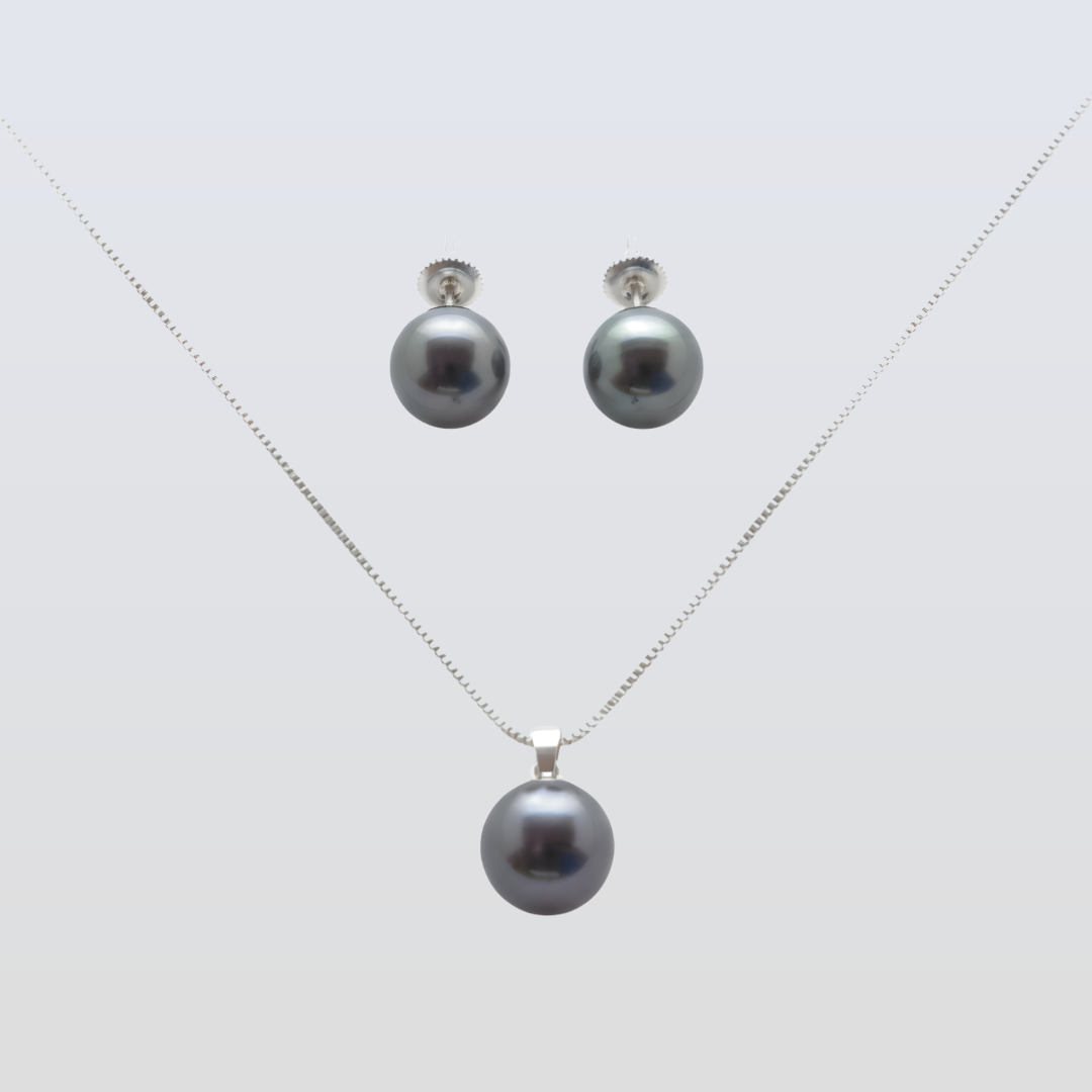 Pearl necklace and earrings set on a light gray background