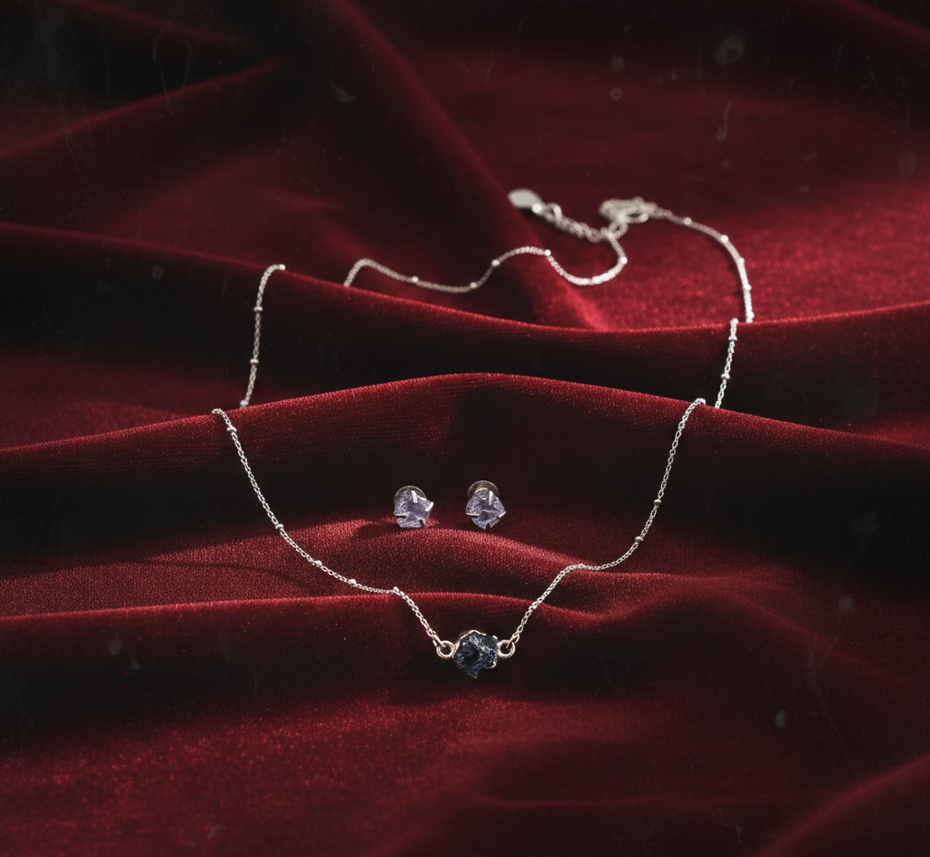 Necklace and earrings on a red fabric background