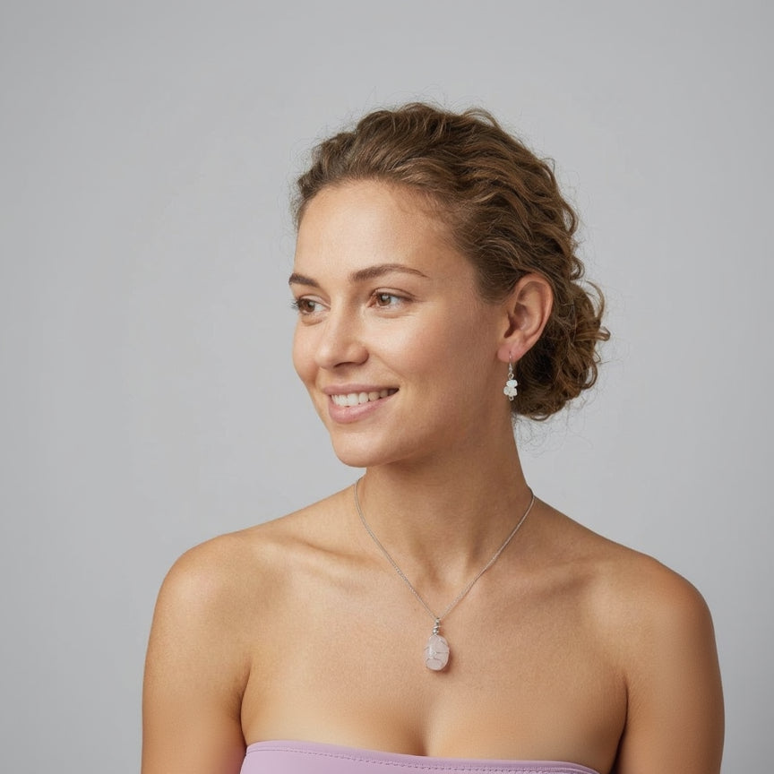 Woman wearing a necklace and earrings on a gray background