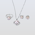 Pearl jewelry set with necklace, ring, and earrings on a light gray background