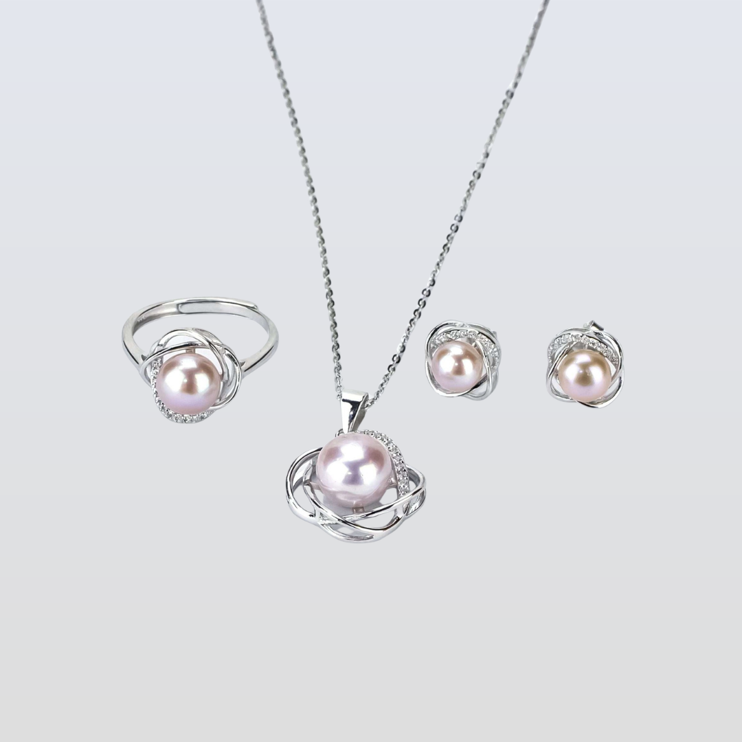 Pearl jewelry set with necklace, ring, and earrings on a light gray background