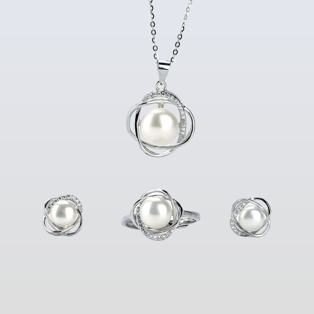 Pearl jewelry set with necklace, ring, and earrings on a light gray background
