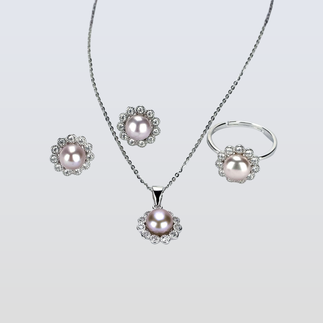 Pearl jewelry set with necklace, earrings, and ring on a light gray background