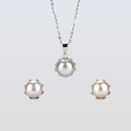 Pearl necklace and earrings set on a light gray background