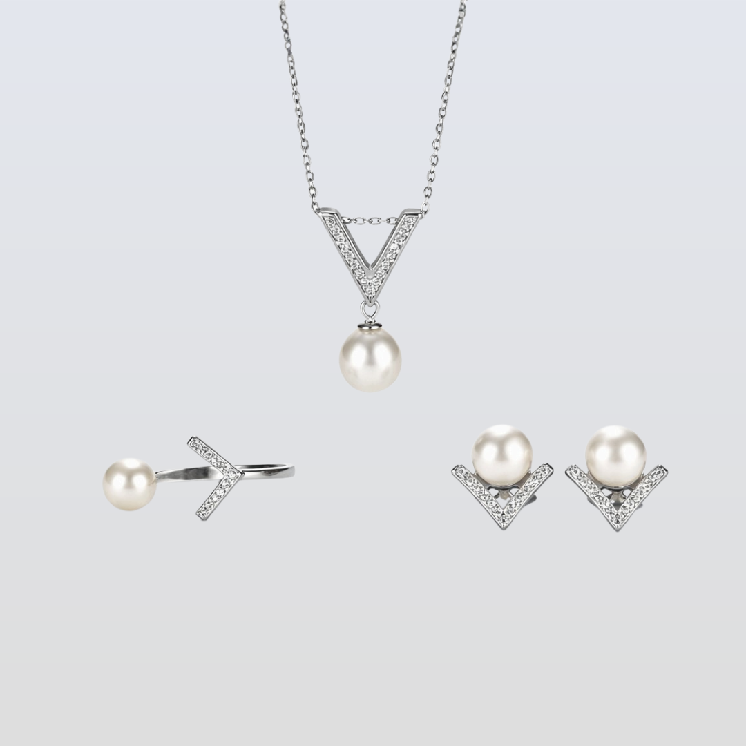 Pearl jewelry set with necklace, earrings, and ring on a light gray background