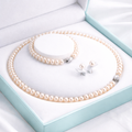 Pearl necklace and earrings set in a heart-shaped box