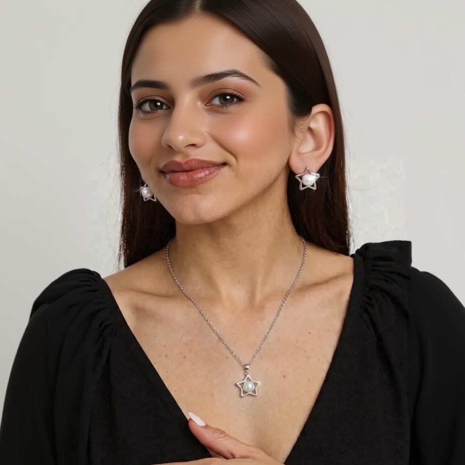 Star-shaped necklace and earrings on a person wearing a black top.