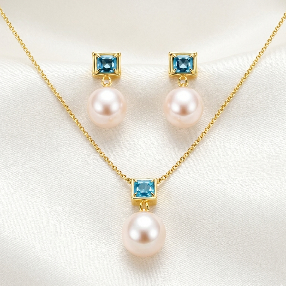 Pearl necklace and earrings with blue gemstones on a white background