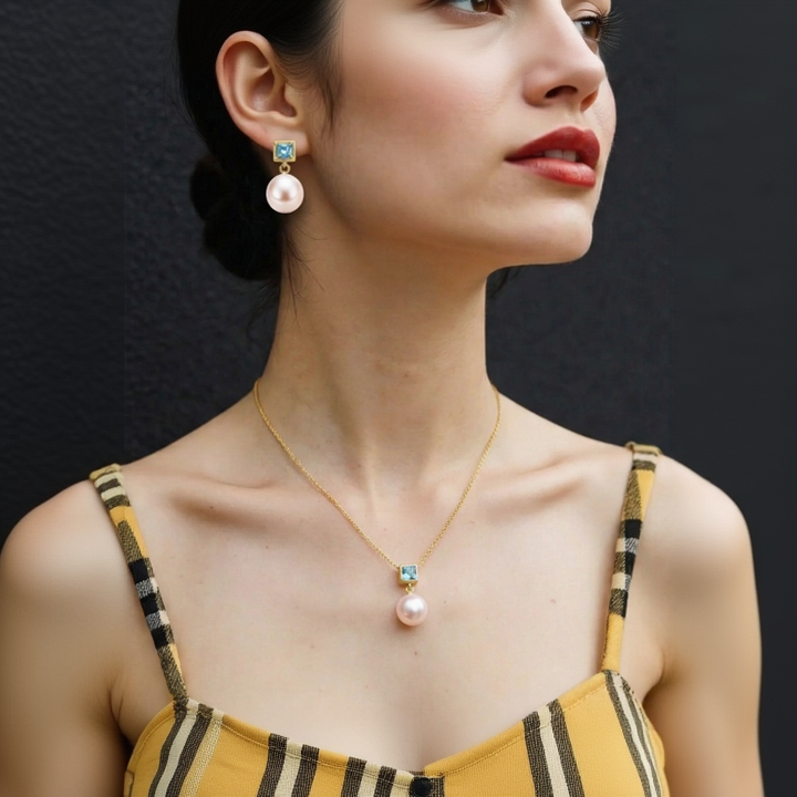 Woman wearing pearl earrings and a necklace with a black background