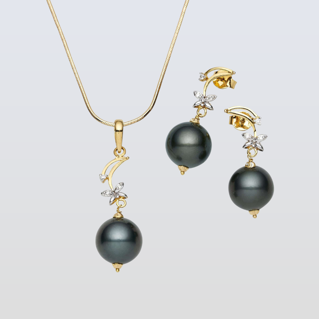 Pearl necklace and earrings set on a light gray background