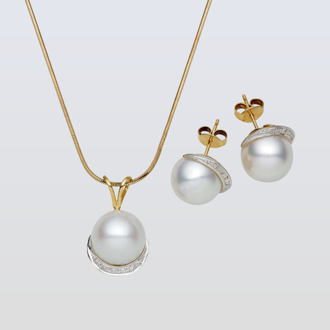 Pearl necklace and earrings set on a light gray background