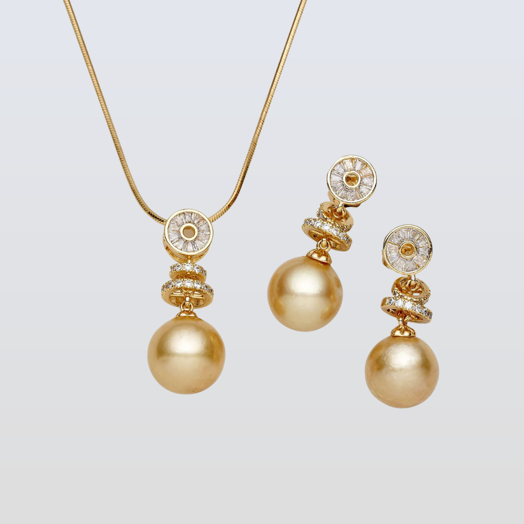 Gold necklace and earrings set on a light gray background