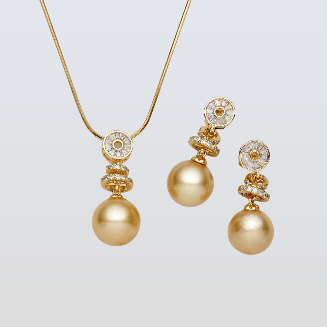 Gold necklace and earrings set on a light gray background