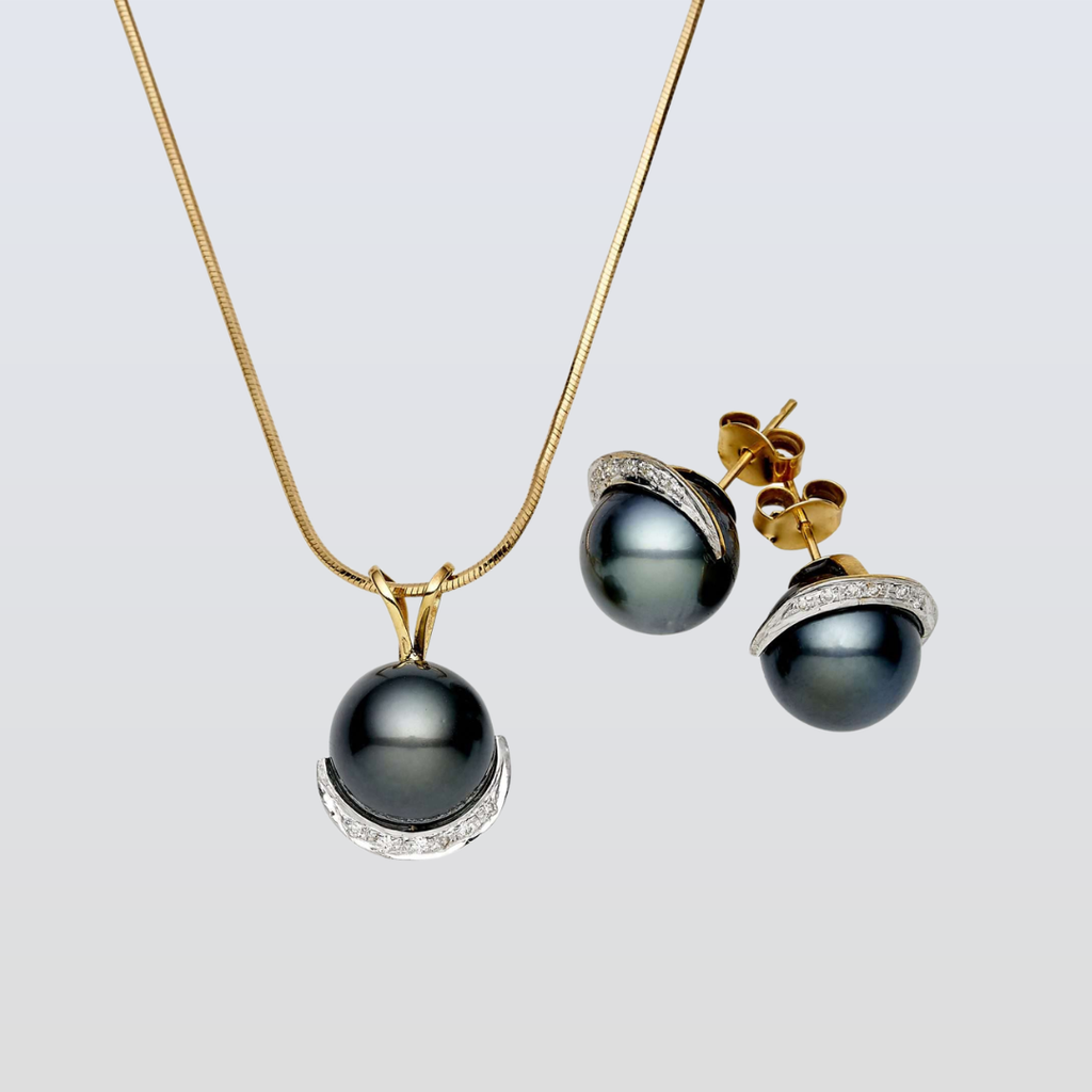 Pearl necklace and earrings set on a light gray background