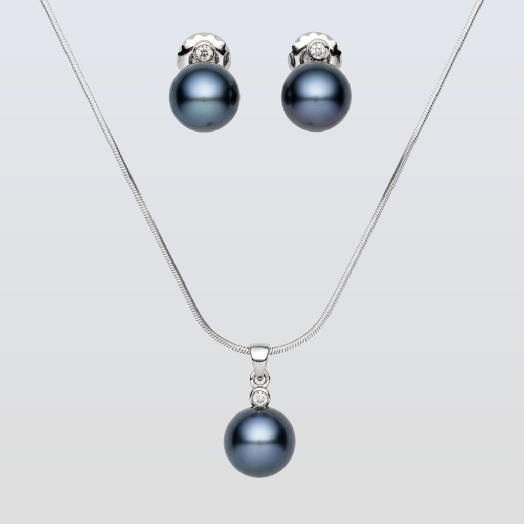 Pearl necklace and earrings set on a light gray background