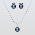 Pearl necklace and earrings set on a light gray background