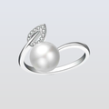 Silver ring with a pearl and leaf design on a light gray background