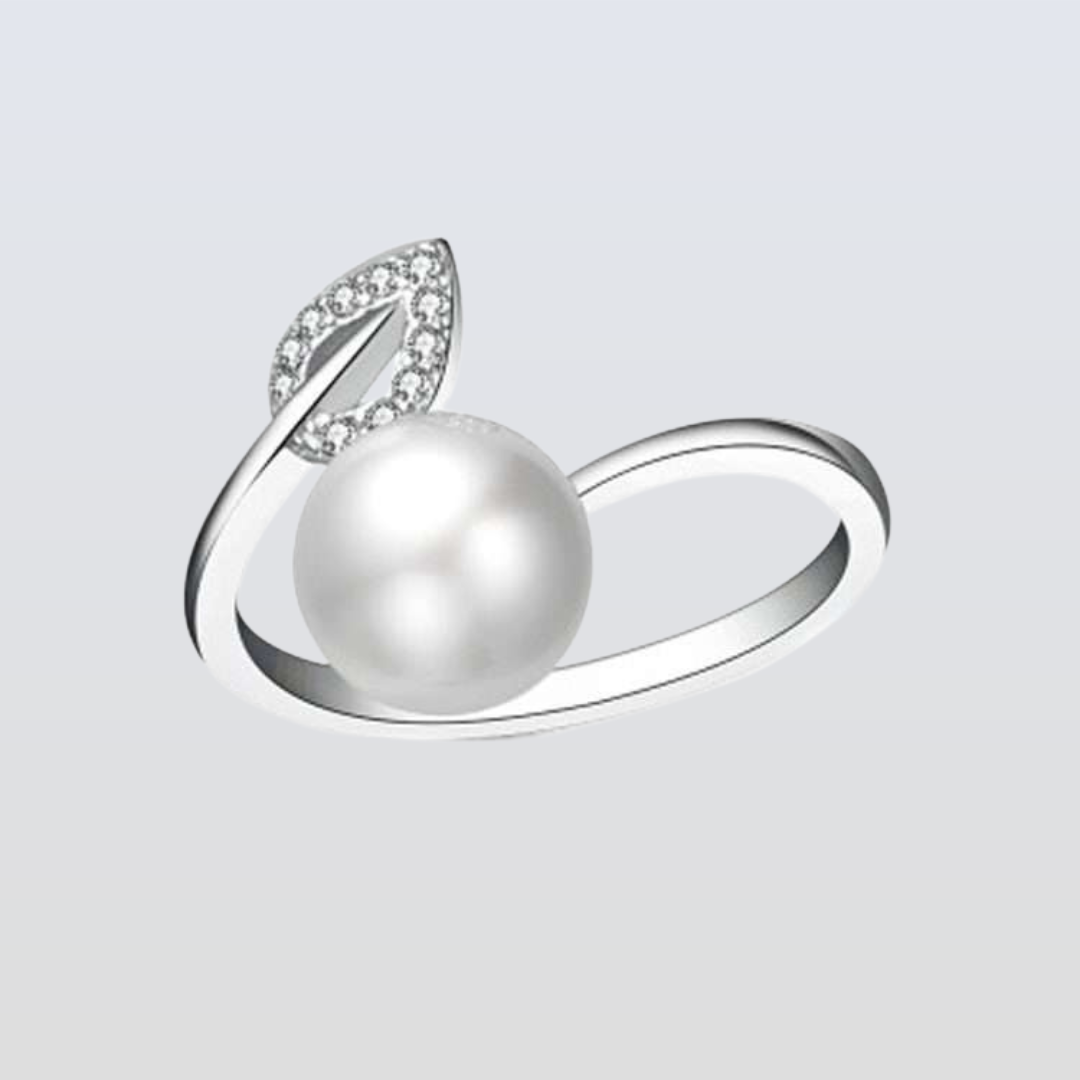 Silver ring with a pearl and leaf design on a light gray background
