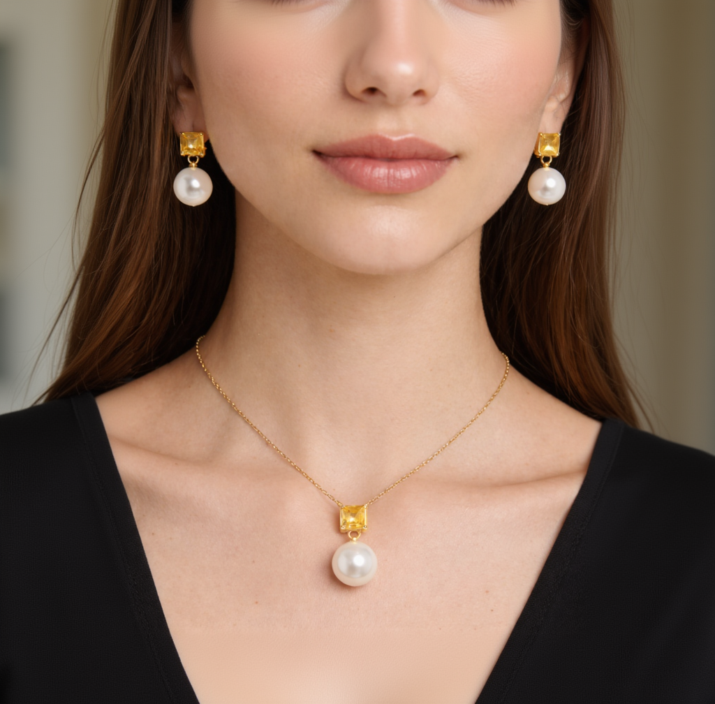 Close-up of a woman wearing pearl earrings and a matching necklace with a gold clasp.